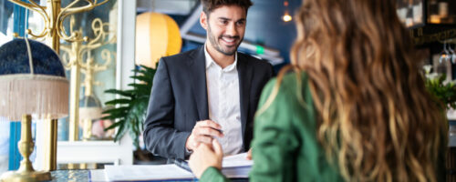 Hotel receptionist assisting guest for checking in