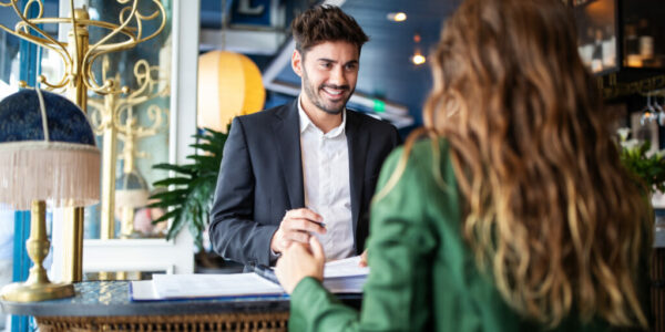 Hotel receptionist assisting guest for checking in