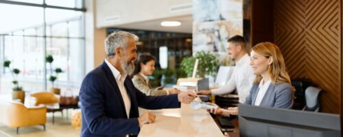 Man paying something with a credit card at the hotel reception