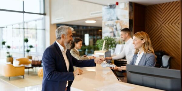 Man paying something with a credit card at the hotel reception