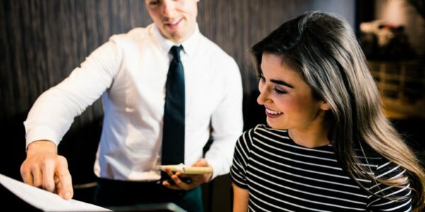 Attractive woman ordering to the waiter from the menu