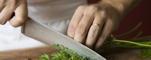 Chef chopping parsley