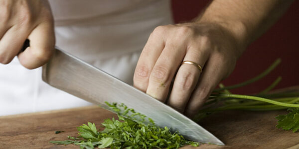 Chef chopping parsley