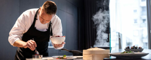 Attractive Young Adult Private Chef Cooking At A Fancy Apartment