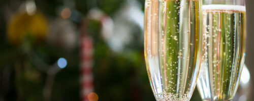 Two Champagne Flutes on Christmas Background