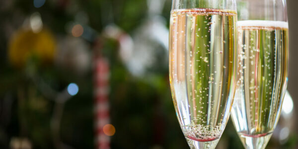 Two Champagne Flutes on Christmas Background