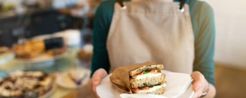 Waitress ready to serve food in cafe