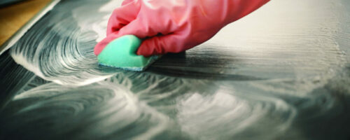 Cleaning kitchen stove.