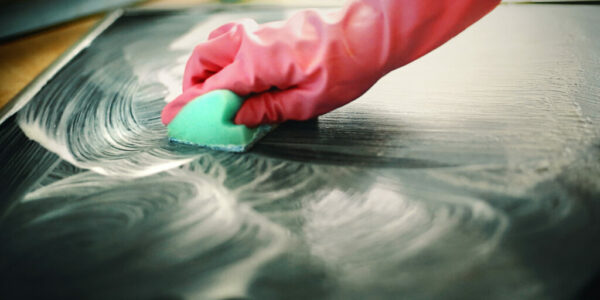 Cleaning kitchen stove.